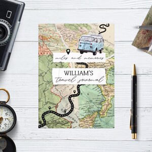 May include: A travel journal featuring a map design, a light blue van illustration, and the text "miles and memories" and "WILLIAM'S travel journal". A compass, camera, pen, and model airplane are also visible.