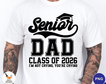 May include: White t-shirt with a black graphic that reads "Senior DAD CLASS OF 2026 I'M NOT CRYING, YOU'RE CRYING." The design includes a graduation cap above the word "Senior."