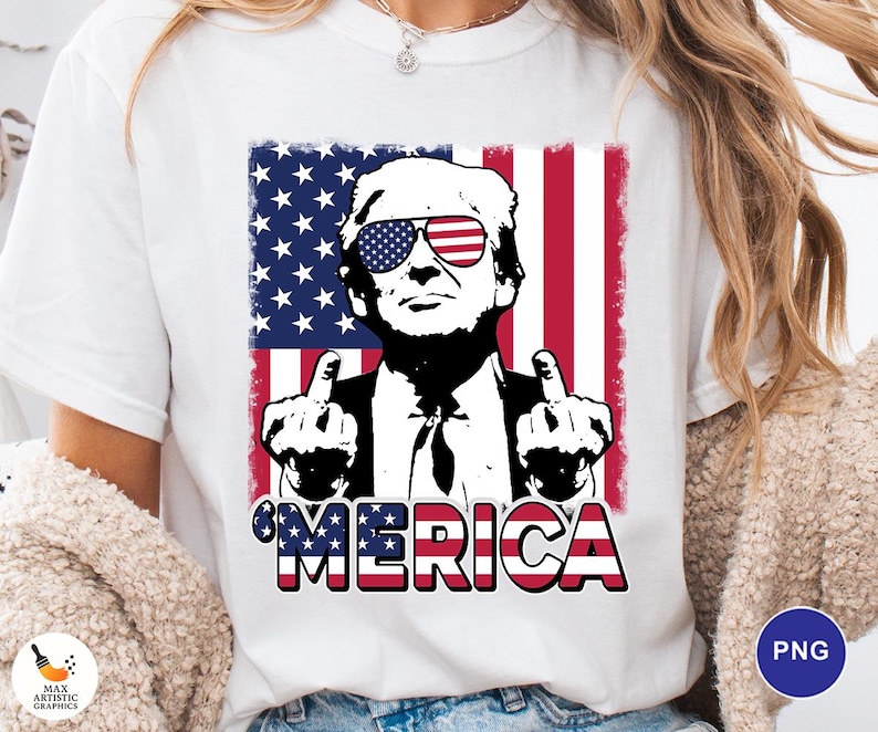 May include: White t-shirt featuring a graphic of a man wearing sunglasses with the American flag design. The man is giving the middle finger with both hands. The word "'MERICA" is printed in red, white, and blue.
