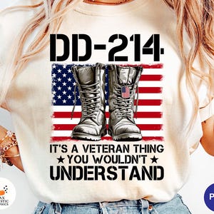 May include: Cream-colored t-shirt featuring a graphic design with the text "DD-214" above a depiction of combat boots in front of an American flag. The text "IT'S A VETERAN THING YOU WOULDN'T UNDERSTAND" is below the flag.