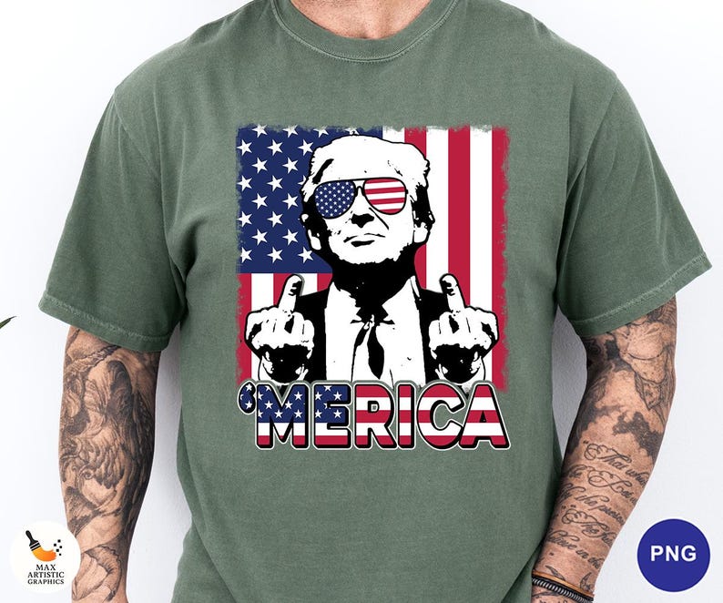 May include: Green t-shirt featuring a graphic of a man wearing sunglasses with an American flag design. The image includes the word "'MERICA" in red, white, and blue. The man is giving the middle finger with both hands.