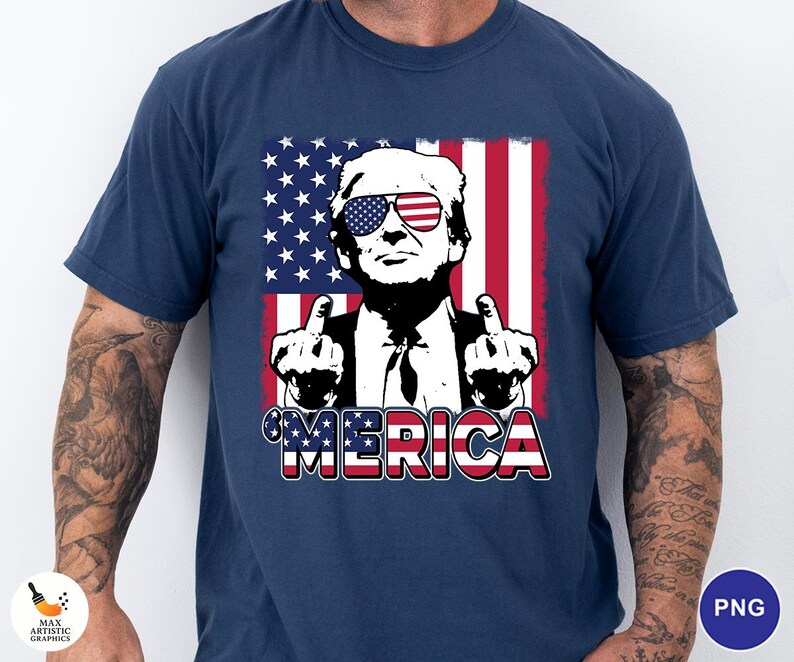 May include: Navy blue t-shirt featuring a graphic of a person wearing sunglasses with an American flag design. The person is giving the middle finger. The word "'MERICA" is printed in red, white, and blue.