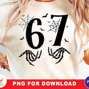 May include: Cream-colored sweatshirt with a black graphic featuring the number 67, spiderwebs, bats, and skeleton hands. The text "PNG FOR DOWNLOAD" is displayed on a red banner at the bottom. A logo is in the lower left corner.
