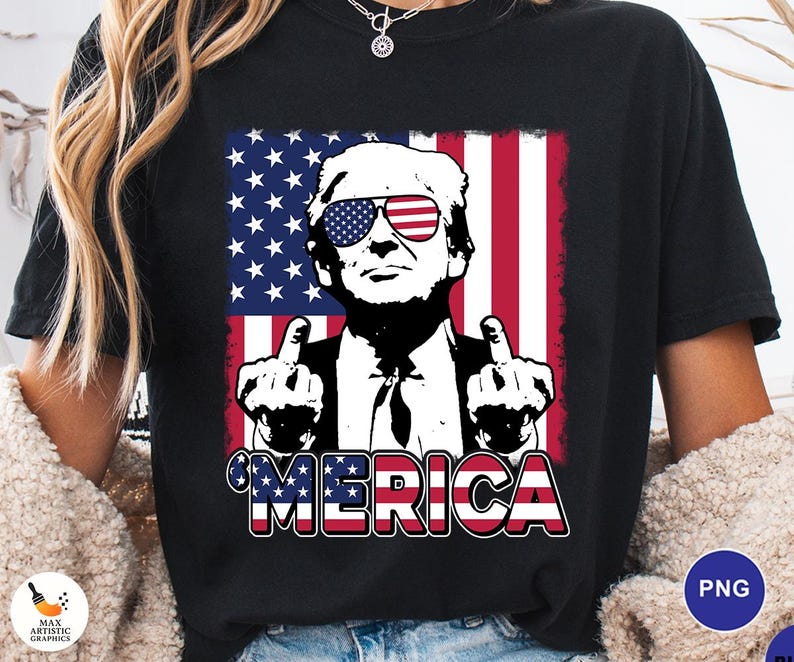 May include: Black t-shirt featuring a graphic of a man wearing sunglasses with the American flag design. The man is giving the middle finger with both hands. The word "'MERICA" is printed in red, white, and blue.