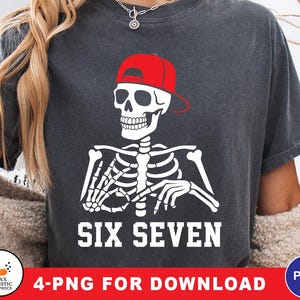 May include: Dark gray t-shirt featuring a white skeleton wearing a red baseball cap. The skeleton's rib cage and arms are visible. The text "SIX SEVEN" is printed in white block letters below the skeleton.