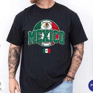 May include: A black short-sleeved t-shirt featuring a graphic of a soccer ball colored with the green, white, and red of the Mexican flag. The word MEXICO is printed in large green letters across the center, with a small Mexican flag icon below.