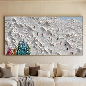 May include: A large horizontal wall art piece featuring a thick, textured impasto oil painting of a snowy mountain landscape. The scene depicts white, swirling snow slopes with small, colorful figures skiing and vibrant, multi-colored pine trees.