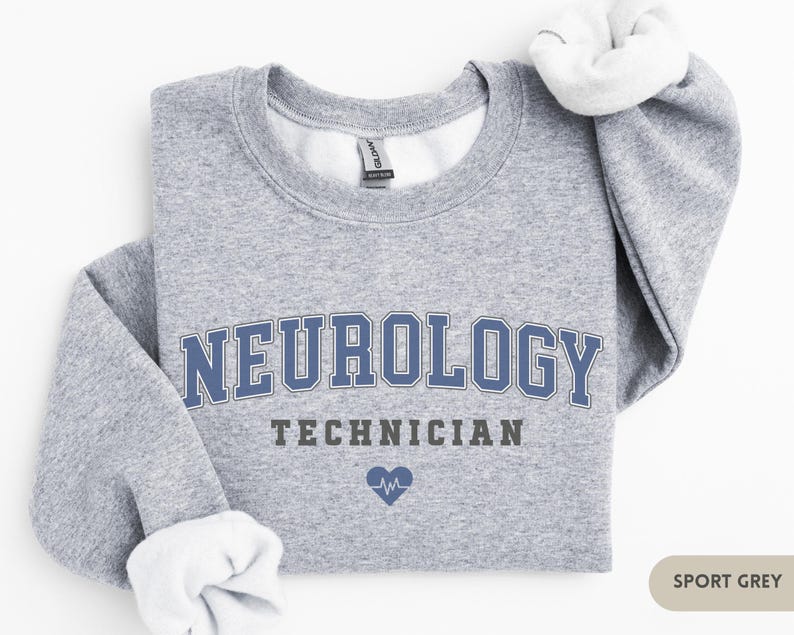 May include: A gray sweatshirt with the text "NEUROLOGY TECHNICIAN" in blue and black lettering. A small blue heart with a heartbeat symbol is below the text. The sweatshirt is labeled "SPORT GREY".