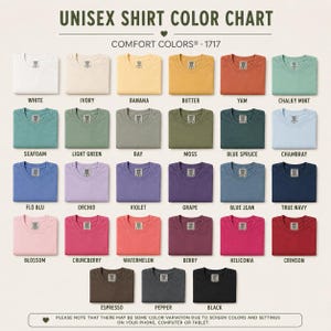 May include: A Comfort Colors 1717 unisex shirt color chart displaying 30 folded t-shirts in various shades including white, ivory, banana, butter, yam, chalky mint, seafoam, light green, bay, moss, blue spruce, chambray, flo blu, orchid, violet, grape, blue jean, true navy, blossom, crunchberry, watermelon, berry, heliconia, crimson, espresso, pepper, and black.