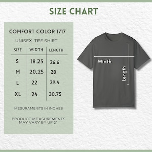 May include: A size chart for a Comfort Color 1717 unisex tee shirt. The chart shows measurements in inches for sizes S, M, L, and XL. The shirt is a dark gray color, with arrows indicating width and length.