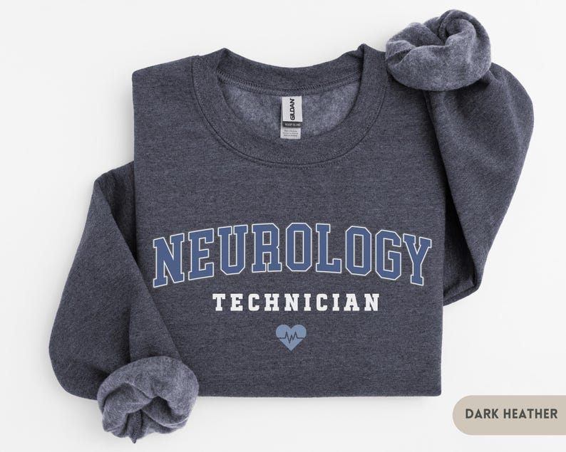 May include: Dark heather grey sweatshirt with the text "Neurology Technician" in white and a blue heart with a heartbeat symbol.