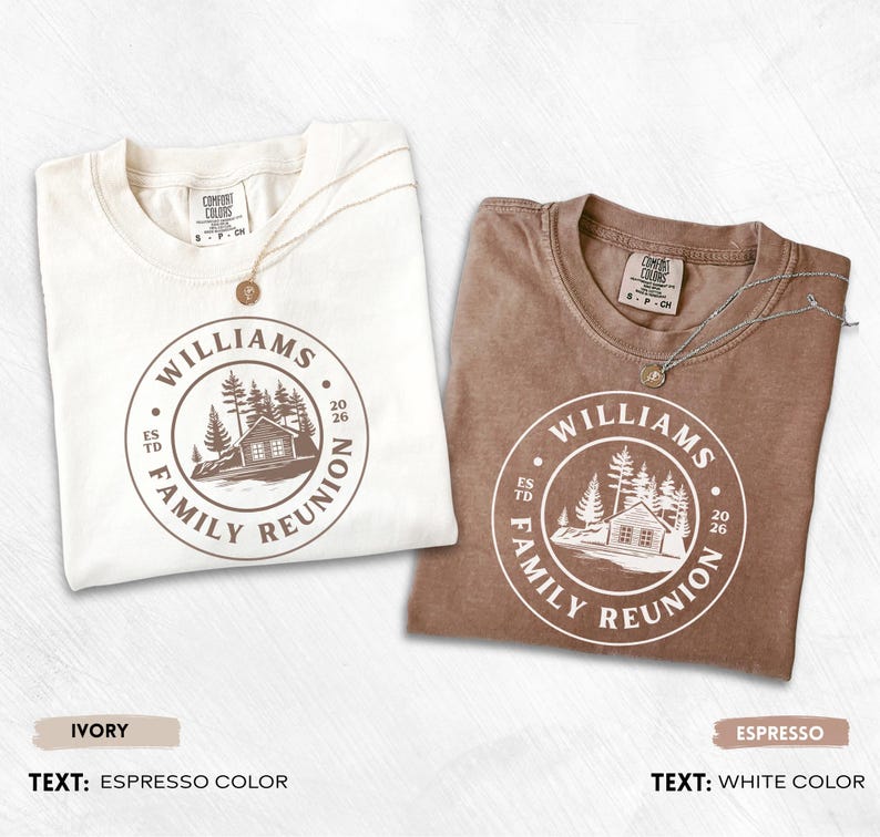 May include: Two short-sleeve t-shirts, one ivory with espresso-colored ink and one espresso with white ink. Both feature a circular graphic with a cabin, pine trees, and the text "WILLIAMS FAMILY REUNION ESTD 2026". Each shirt has a Comfort Colors label.