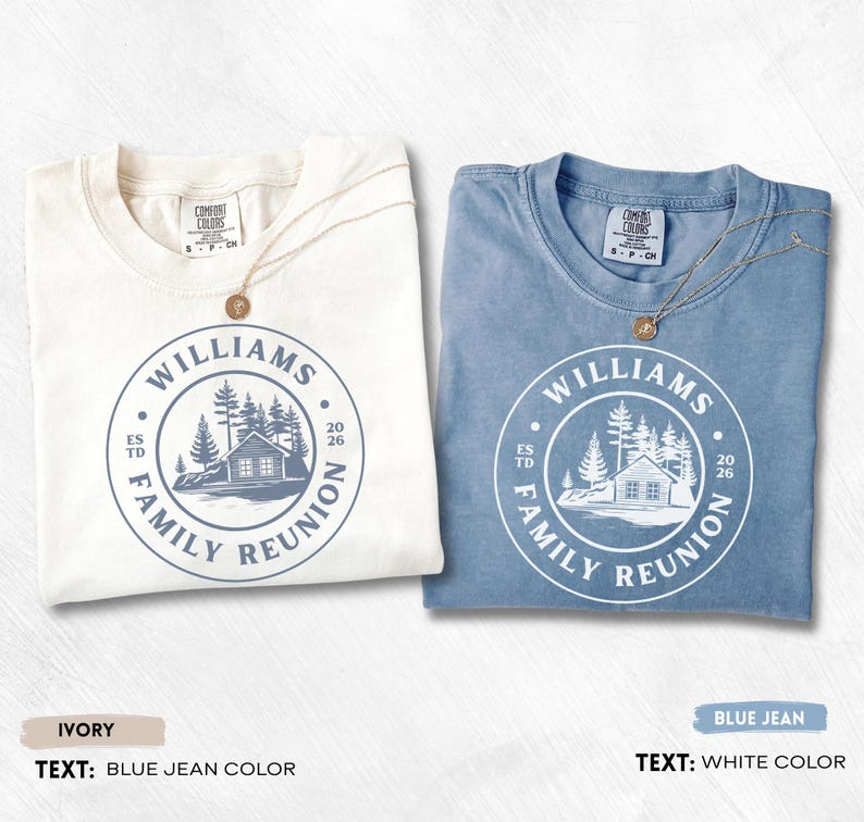 May include: Two short-sleeve t-shirts, one ivory and one blue jean, each featuring a circular graphic with a cabin, pine trees, and the text WILLIAMS FAMILY REUNION ESTD 2026. The ivory shirt has blue jean colored text, and the blue jean shirt has white text.