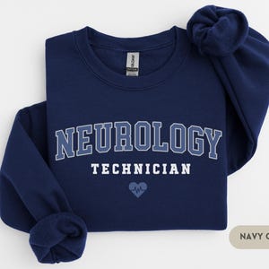 May include: Navy blue sweatshirt with the text "NEUROLOGY TECHNICIAN" in white with a blue heart and EKG symbol.