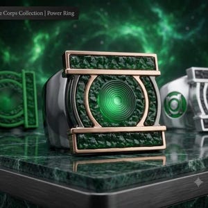 May include: A metallic ring from The Corps Collection | Power Ring featuring a central circular green glowing element surrounded by a textured dark green rectangular frame with rose gold accents and a polished silver band finish.