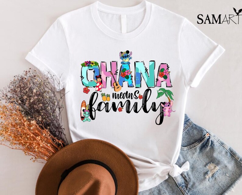 May include: White t-shirt with a colorful graphic design featuring the text "Ohana means family" with Stitch and other Disney characters.