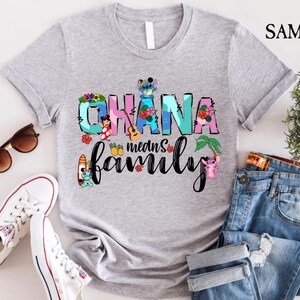 May include: Gray t-shirt with a colorful graphic that says "Ohana means family" with Stitch and other Disney characters from Lilo & Stitch.