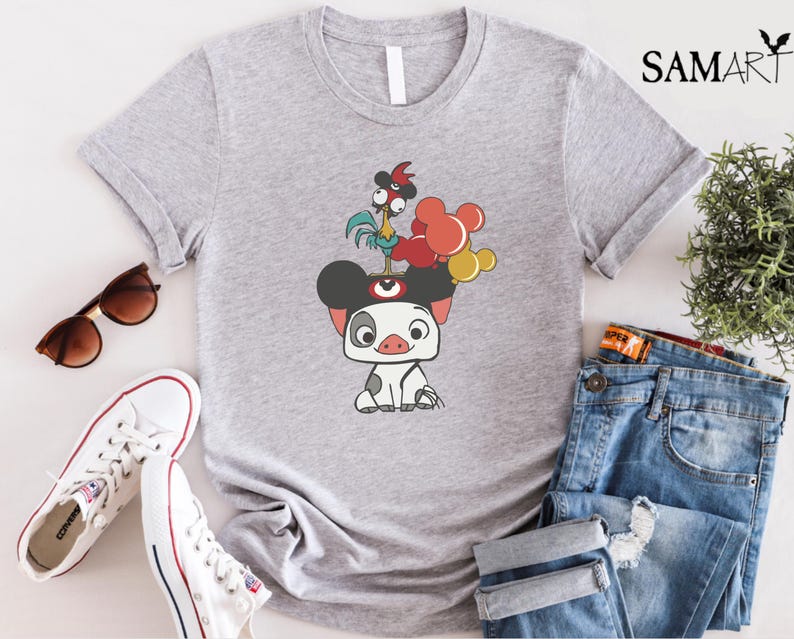 May include: A light gray t-shirt featuring a cartoon illustration of a pig with mouse ears, a rooster, and balloons. The shirt is paired with blue jeans, white sneakers, and sunglasses.