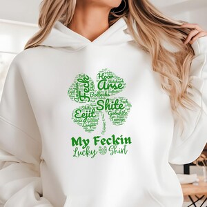 This Irish Swear Words Hoodie features a bold green shamrock filled with cheeky Irish expletives like Feck, Eejit, Gobshite, & Bollocks. Made from soft, cozy fabric, this unisex hoodie is perfect for St. Patrick’s Day fun, pub nights, and good craic!