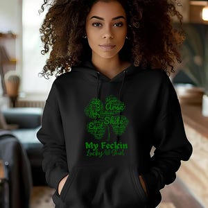 May include: Black hoodie with a green four-leaf clover graphic. The clover is made up of words, including "My Feckin Lucky Shirt".