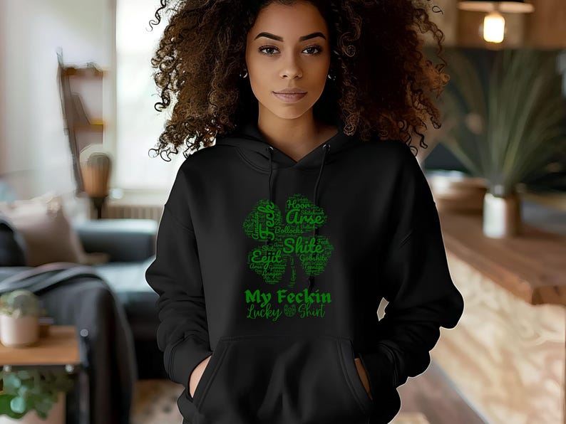 May include: Black hoodie with a green four-leaf clover graphic. The clover is made up of words, including "My Feckin Lucky Shirt".