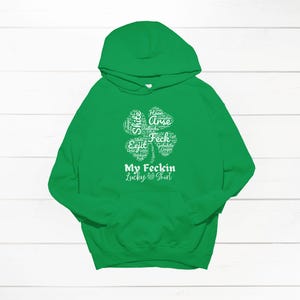 May include: Green hooded sweatshirt with a white four-leaf clover graphic that says "My Feckin Lucky Shirt".