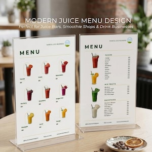 May include: Two clear acrylic juice menu displays on a table. The menus feature colorful illustrations of various juice and smoothie options, with text including "MENU" and "JUICES". The top text reads "MODERN JUICE MENU DESIGN".