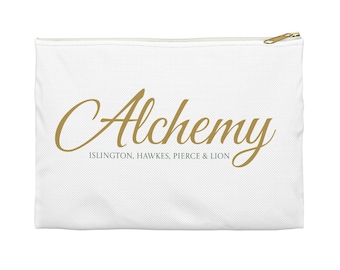 May include: White canvas pouch with a gold zipper and the word "Alchemy" in gold script. Below the word "Alchemy" is the text "ISLINGTON, HAWKES, PIERCE & LION" in a smaller font. The pouch is rectangular and has a simple design.