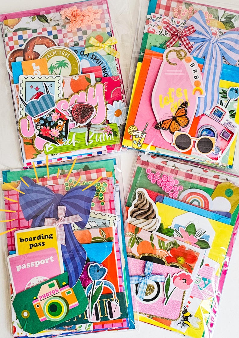 May include: Four colorful, decorative paper packs filled with travel-themed ephemera. Each pack features a variety of stickers, tags, and paper cutouts with images of cameras, butterflies, and cocktails. The packs are sealed in clear plastic.
