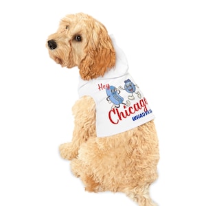 May include: A white hooded dog shirt with a red and blue graphic of a hot dog and a blue blueberry with the text "Hey Chicago Whadaya Say".
