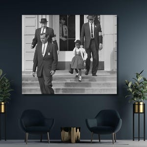 May include: Black and white photograph of a young girl in a dress walking down a set of stairs with two men in suits walking behind her.