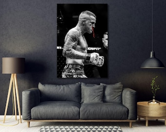 May include: A black and white wall art print featuring a mixed martial arts fighter in profile. The fighter has visible tattoos on the arm, wears UFC gloves, and has a streak of bright red blood running from the nose against the monochrome scene.