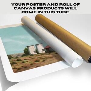 May include: A rolled canvas print of a painting depicting three white silos and a red-roofed building in a rural landscape. The canvas is being unrolled from a brown cardboard tube. The text "YOUR POSTER AND ROLL OF CANVAS PRODUCTS WILL COME IN THIS TUBE." is visible at the top of the image.