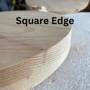 May include: Close-up of a light-coloured wooden object with a square edge. The text "Square Edge" is printed in black. The wood grain is visible, and the edge shows a detailed joinery technique.