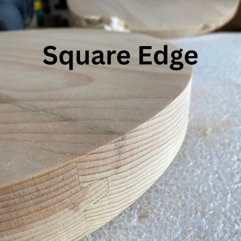 May include: Close-up of a light-coloured wooden object with a square edge. The text "Square Edge" is printed in black. The wood grain is visible, and the edge shows a detailed joinery technique.