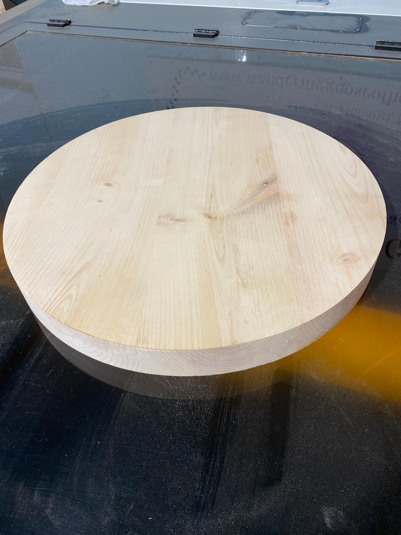 May include: A circular, unfinished wooden tabletop. The light-coloured wood grain is visible across the surface. The tabletop is approximately 3.8 cm thick and is ready for staining or painting. Ideal for DIY projects or as a replacement tabletop.