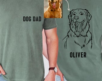 May include: Sage green t-shirt with the text "DOG DAD" on the front. The back features a black line drawing of a Golden Retriever with the name "OLIVER" below. A photo of a Golden Retriever is also included.