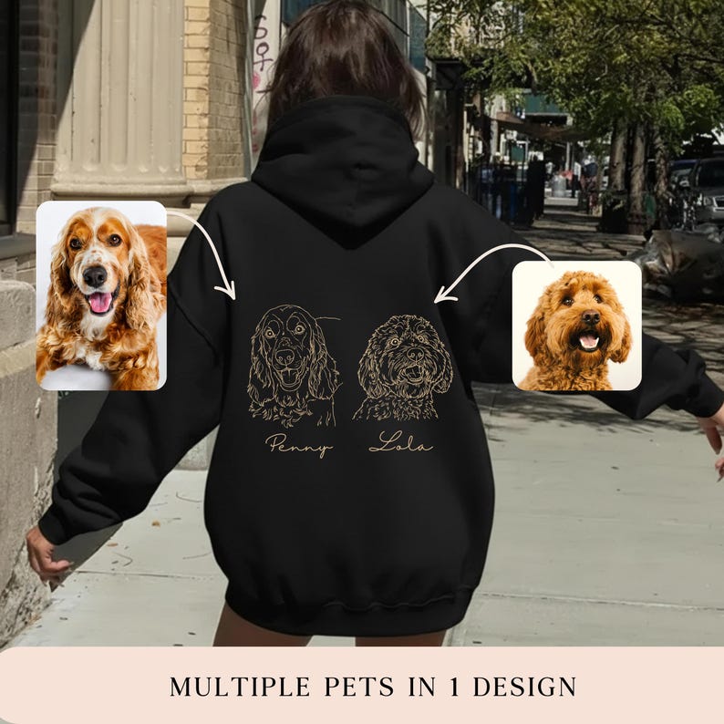 May include: Black hoodie with line art portraits of two dogs, labelled "Penny" and "Lola." The design includes two dog photos. The bottom of the hoodie reads "MULTIPLE PETS IN 1 DESIGN."