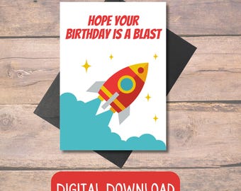 May include: A printable birthday card with a rocket ship design. The card says "Hope your birthday is a blast".