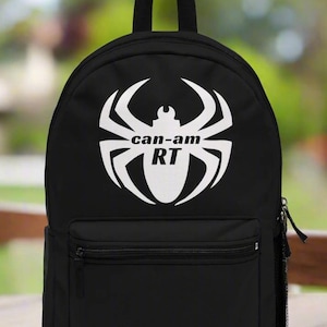 May include: Black backpack with a white spider graphic and the text "can-am RT" on the front.