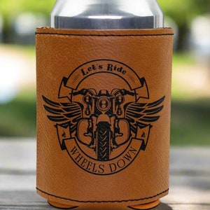 May include: Brown leather can cooler with a black motorcycle graphic and the text "Let's Ride Wheels Down".