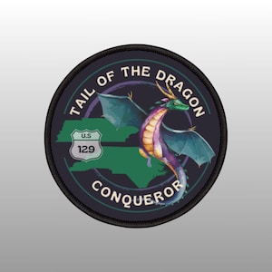 May include: A black and green embroidered patch featuring a purple and blue dragon, a green and blue map of North Carolina, and the text "Tail of the Dragon Conqueror" and "U.S. 129".