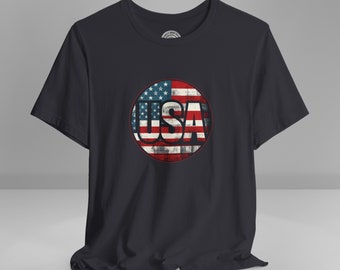 May include: A black t-shirt with a distressed circle graphic featuring the American flag and the word "USA" in white lettering.