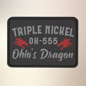 May include: A black and gray embroidered patch with the text "Triple Nickel OH-555 Ohio's Dragon" and two red dragon heads.