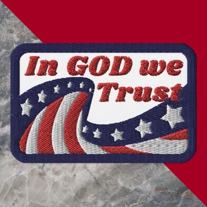 May include: A blue and white embroidered patch with red stitching. The patch features a stylized American flag with the words "In God We Trust" in red lettering.