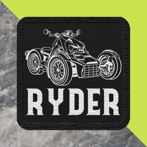 May include: Black embroidered patch with a white outline of a three-wheeled vehicle and the name "RYDER" in white text.
