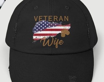 May include: Black distressed baseball cap with a faded American flag and the text "Veteran Wife" in brown lettering.