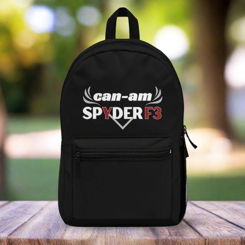 Puede incluir: Mochila negra con un logotipo blanco "can-am SPYDER F3" en una fuente blanca estilizada. El logotipo tiene acentos rojos.