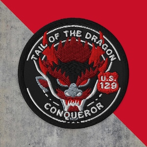 May include: Black and white embroidered patch with a red dragon head in the center. The patch reads "Tail of the Dragon Conqueror" and "U.S. 129" in white text.