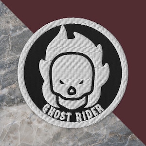 May include: A white embroidered patch with a black background. The patch features a stylized image of a skull with flames and the text "Ghost Rider".